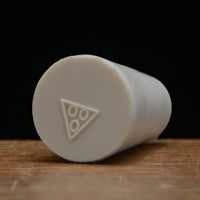 A rubber stopper, approx. 9 mm in diameter. Sized to fit the hole in any drilled rubber stopper.